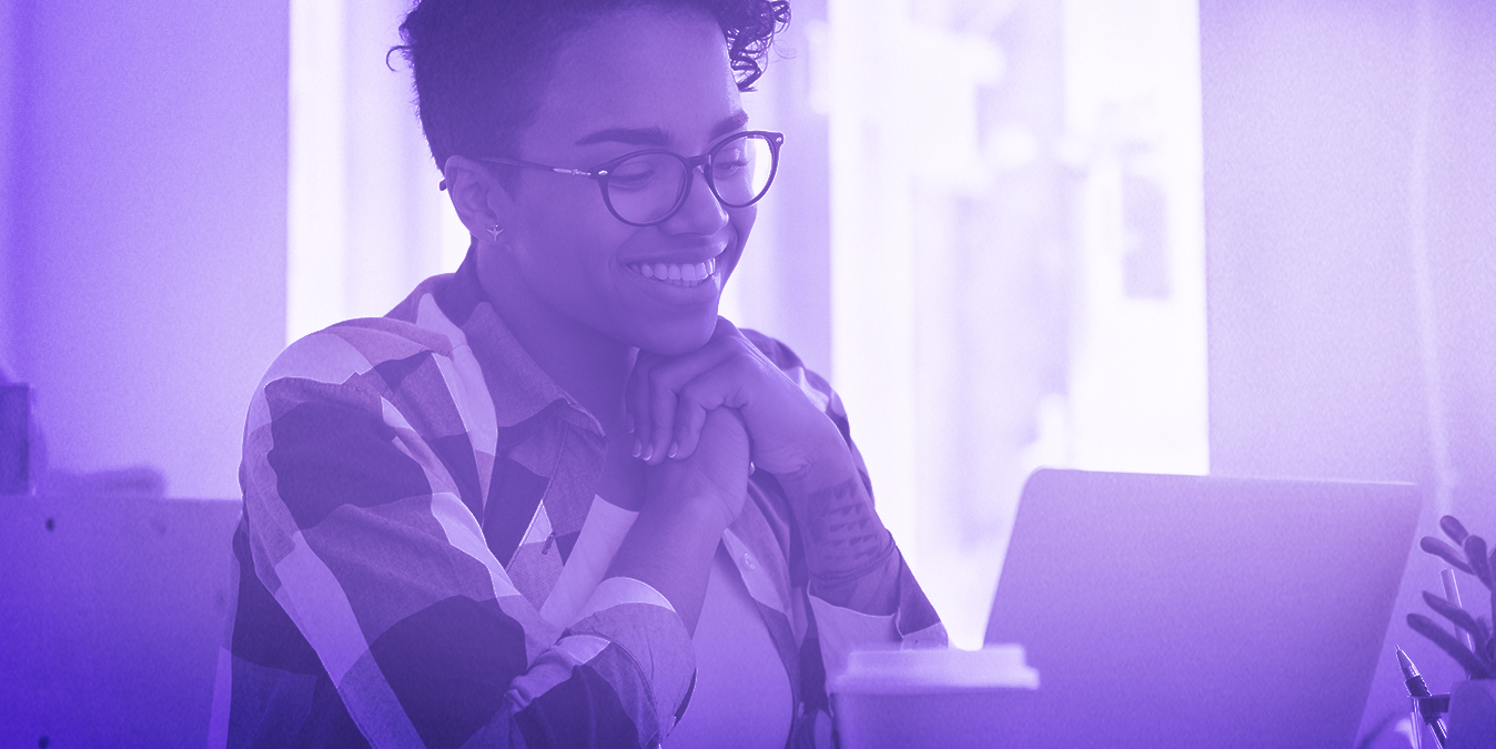 Smiling woman looking at a laptop