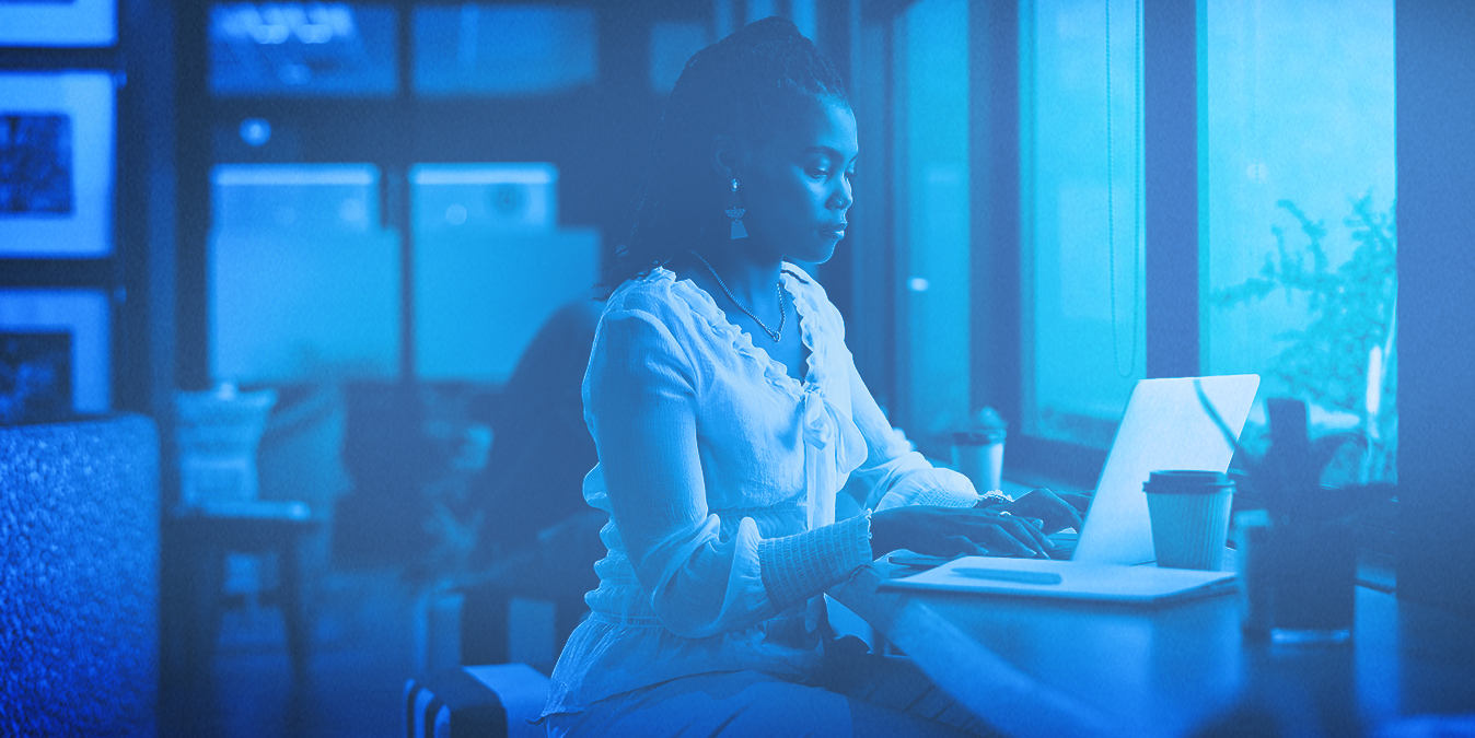 Woman working on a computer in a coffee shop